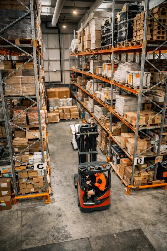 Logistics warehouse with workers managing inventory